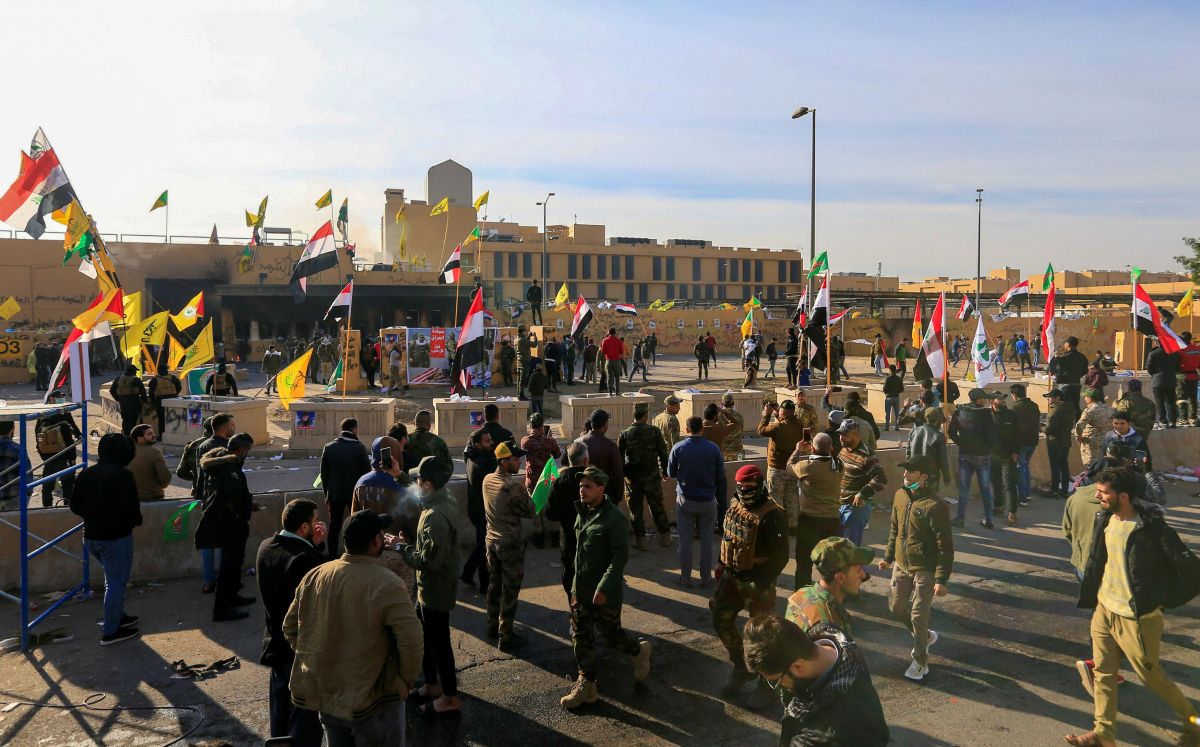 Protesters and militia fighters gather to condemn air strikes on bases belonging to Hashd al-Shaabi (paramilitary forces), outside the U.S. Embassy in Baghdad, Iraq January 1, 2020.