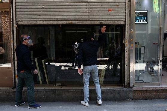 A shop owner wears a protective face mask, as he openes up his store, following the outbreak of the coronavirus disease (COVID-19), after shopping malls and bazaars reopened in Tehran, Iran, April 20, 2020. ATTENTION EDITORS - THIS PICTURE WAS PROVIDED BY A THIRD PARTY